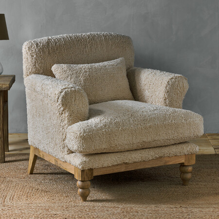 Oversized comfy reading chair or boucle armchair with a soft, fluffy teddy bear style upholstery in off white and a wooden base 2