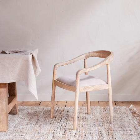 Mango wood dining chair with a pale natural finish and a linen upholstered seat