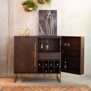 Dark wood drinks cabinet sideboard with gold handles and legs and a retro herringbone pattern