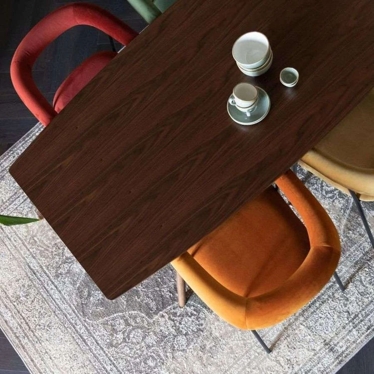 Colourful chairs around a wood dining table from above