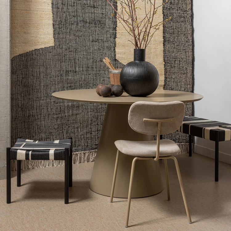 Various different chairs and stools around a circular brown table
